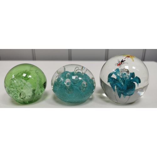 210 - A collection of twelve good quality glass paperweights, with a variety of patterns.