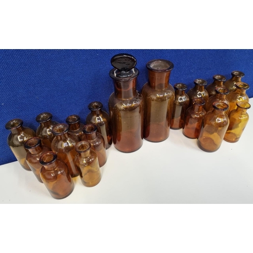 216 - A collection of twenty apothecary/medicine, amber glass bottles, of varying sizes. One with the orig... 