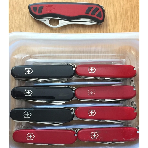 453 - A collection of nine Swiss Army knives (five red, three black, one red & black)