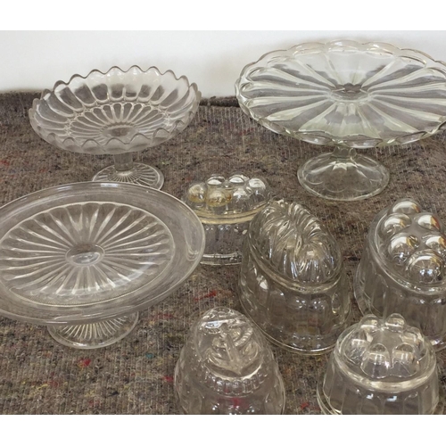 218E - A mixed lot of vintage , glass kitchenware. To include two cake stands, centre piece, & five jelly m... 