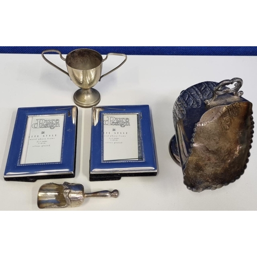 435 - A collection of silver plated items, to include a miniature scuttle with scoop, a trophy cup dated 1... 