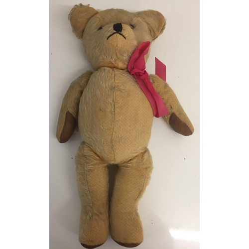 4086 - An early 20th century growler Teddy Bear, with pink ribbon. Growler requires attention. Height 48cm.