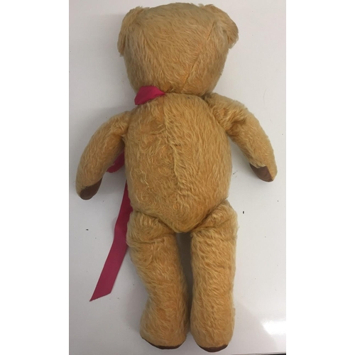 4086 - An early 20th century growler Teddy Bear, with pink ribbon. Growler requires attention. Height 48cm.