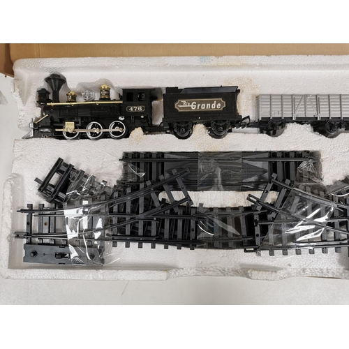 2704 - A boxed, battery powered, 'New Bright' Rio Grande train set. To include engine, three carriages, sta... 