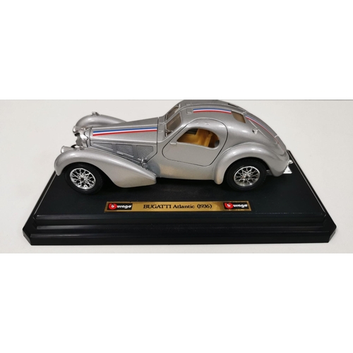 2380 - A collection of four, unboxed, Burago sports cars. Three 1:18 scale plinth mounted & another 1:43 sc... 