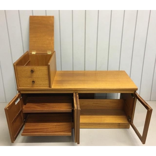 129 - A mid-century, Nathan teak entertainment unit. False drawers over two double cupboards (one glazed).... 