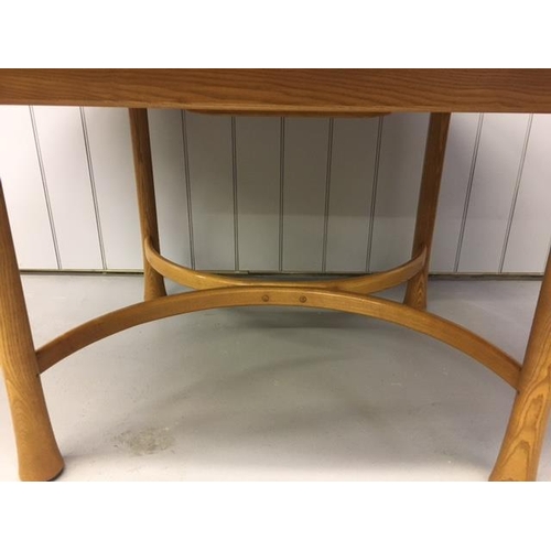 1048 - An Ercol 'Saville' extending dining table. Model 926. Internally housed extension leaf, extends from... 