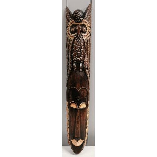 1510 - A large, carved African wall mask. Dimensions(cm) H101, W17, D7.