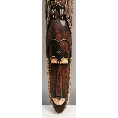 1510 - A large, carved African wall mask. Dimensions(cm) H101, W17, D7.