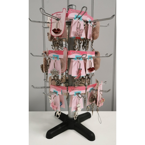 1516 - A rotating retail display tree stand, with a quantity of unopened keyrings & phone charms. Dimension... 