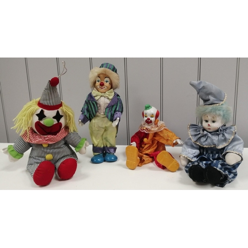 1523 - A collection of four poseable clowns, each with moveable limbs.