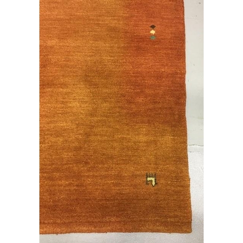 194 - A large Gabbeh rug. 335cm x 244cm. Material - 100% wool pile. Colour - tones of burnt orange, with s... 