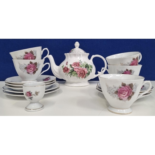 559 - An eclectic rose-themed, floral tea set, comprising of a teapot & an assortment of different cups & ... 