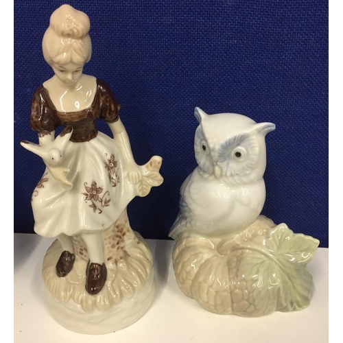 584 - A porcelain owl figure, by M Requena Valencia, together with a young girl figurine.