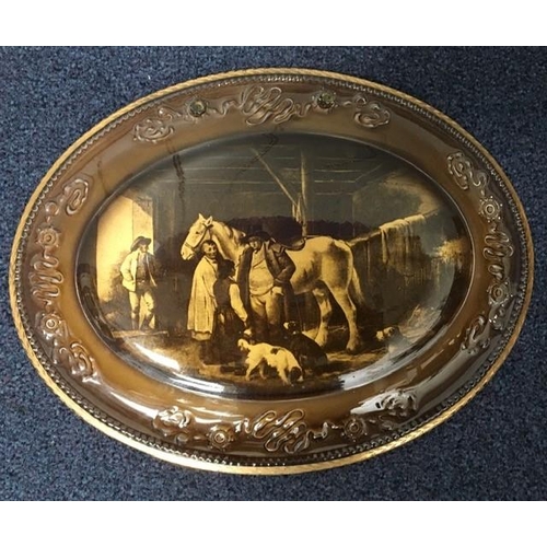 608 - A glazed, oval 'Royal Ware' display plate, with a stable scene. Width 28cm.