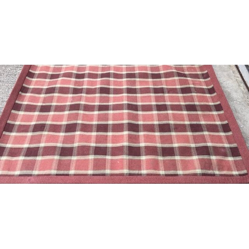 197 - A good quality, pure wool rug, by 'Anta', Scotland, in a terracotta/check pattern. 245cm x 197cm.