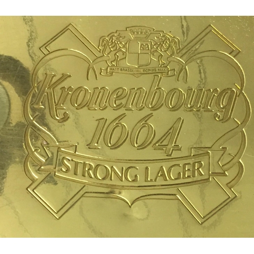 240 - A branded 'Kronenbourg' drip-tray, together with a pair of matching steins, by 'Wade'.