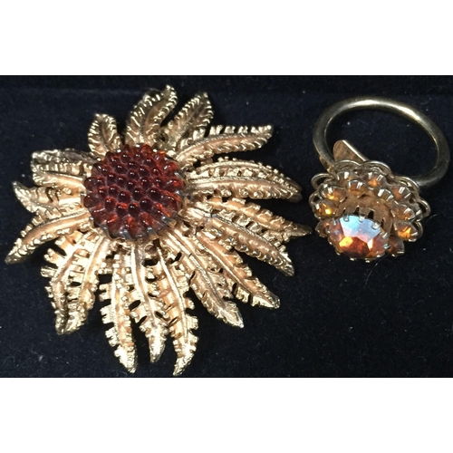 411 - Two, vintage 'Sarah Cov.' items. To include a sunflower gold-plated brooch, together with a cluster ... 