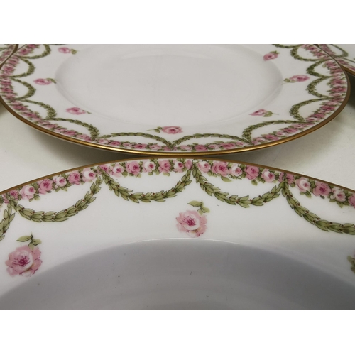 555 - A set of six 'Theodore Haviland' plates.  White with a gold rim, decorated with a pink rose & green ... 