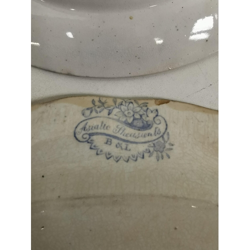 560 - A mixed lot of three pieces of ceramic tableware. To include a willow pattern plate & two serving pl... 