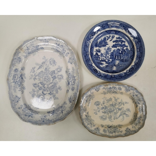 560 - A mixed lot of three pieces of ceramic tableware. To include a willow pattern plate & two serving pl... 