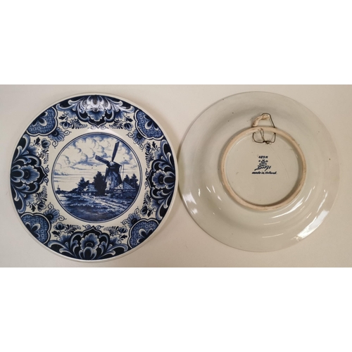 570 - A set of three Delft display plates. Two with a windmill design (stamped 423M) & another with a flor... 