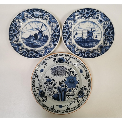 570 - A set of three Delft display plates. Two with a windmill design (stamped 423M) & another with a flor... 