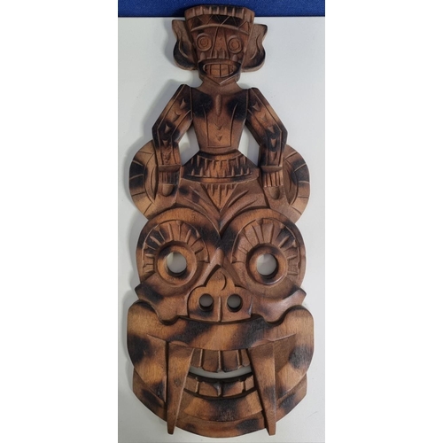 658 - A mid-20th century, hand-carved wooden totem style mask with charred pattern to face. Likely Tiki. D... 