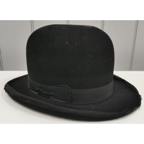 716 - A vintage, black Bowler-hat, by 