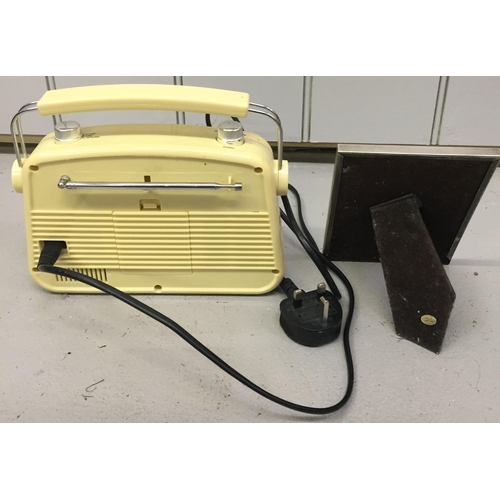 816 - A retro-style electronic radio, by 'Bush'. Model no. JN-7024. Together with a silver-plated photo fr... 