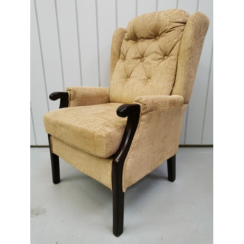 1011 - A fireside, button-back chair by 'Care Co.', in a gold-coloured fabric & dark-wood trim. Dimensions(... 