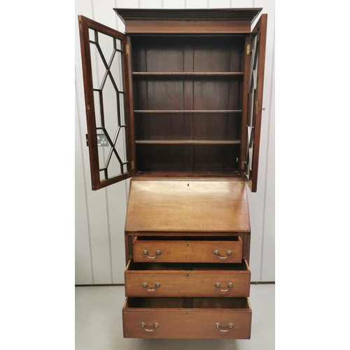 1017 - An Edwardian, mahogany bureau-bookcase. Glazed top, with three adjustable shelves over fall front, f... 