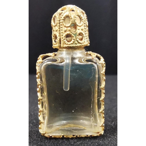 1082 - A vintage, ornate, miniature perfume bottle. Dimensions(cm) H3, W1.5, D1.