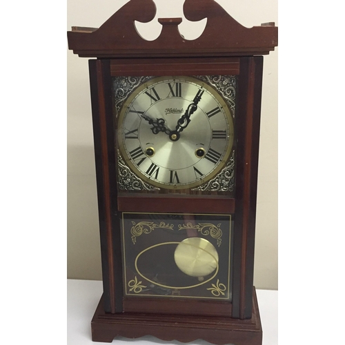 1186 - A vintage 'Highlands' wall clock, with key. Dimensions (cm) H49, W25. Untested.