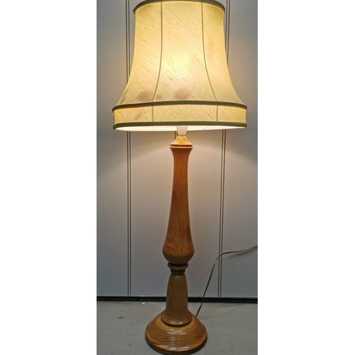 1548 - A vintage, turned oak lamp, with cream shade. PAT test failure, will need re-wiring. Height 87cm, di... 