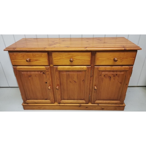 1005 - A solid pine sideboard with three drawers & a triple cupboard area. Dimensions(cm) H87, W134, D45.