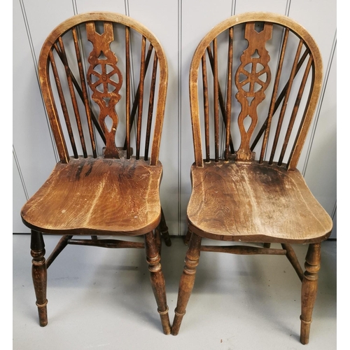 1010 - A pair of wheel back Windsor chairs. Dimensions(cm) H90(39 to seat), W39, D46.