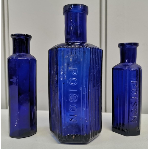 Two cobalt blue bottles, marked 'POISON', together with another unmarked example. Respective dimensions(cm) H13/9/10, W5/4/4.