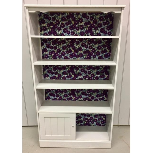 37 - A painted bookcase, with three shelves over a double sliding door cupboard. Dimensions(cm) H160, W89... 