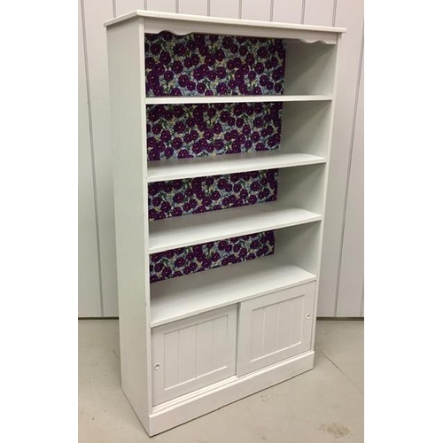 37 - A painted bookcase, with three shelves over a double sliding door cupboard. Dimensions(cm) H160, W89... 