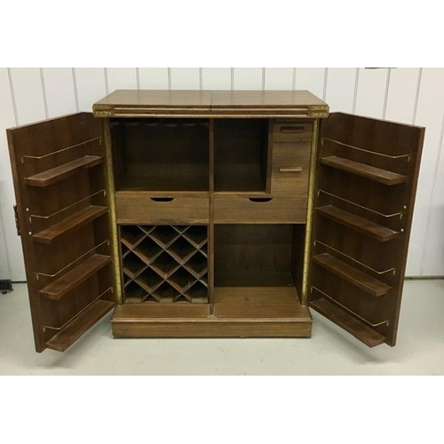 53 - A solid oak/panelled, metamorphic drinks bar. Features hinged opening glass holders & a hinged, exte... 