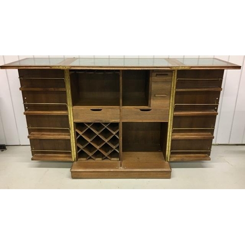 53 - A solid oak/panelled, metamorphic drinks bar. Features hinged opening glass holders & a hinged, exte... 