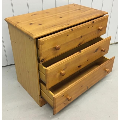 64 - A pine coloured chest of three drawers. Dimensions(cm) H69, W83, D44.