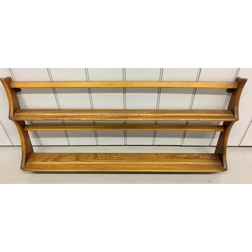 91 - An Ercol wall-mountable plate rack. Dimensions(cm) H50, W97, D13.