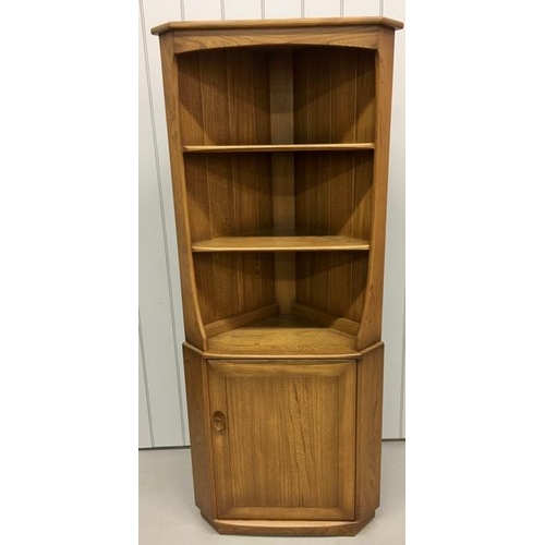 92 - An Ercol dark elm corner display unit, with twin shelves over a single shelved cupboard. Dimensions(... 