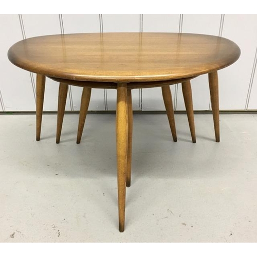 94 - A set of three Ercol dark elm pebble tables. Largest dimensions(cm) H40, W65, D44.