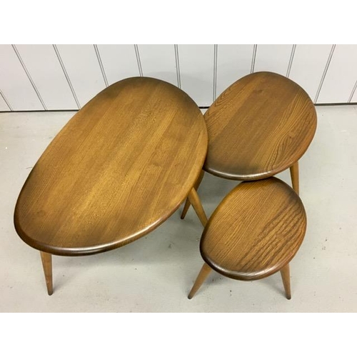 94 - A set of three Ercol dark elm pebble tables. Largest dimensions(cm) H40, W65, D44.