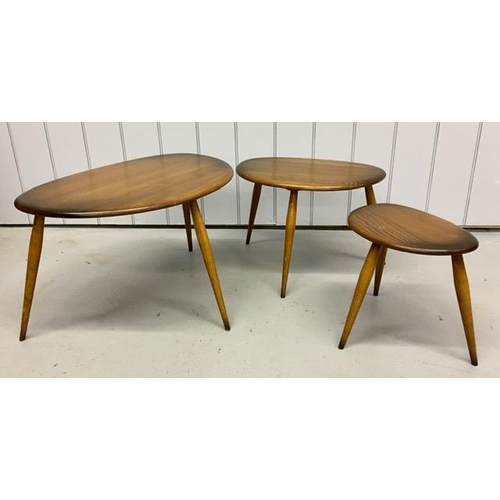 A set of three Ercol dark elm pebble tables. Largest dimensions(cm) H40, W65, D44.