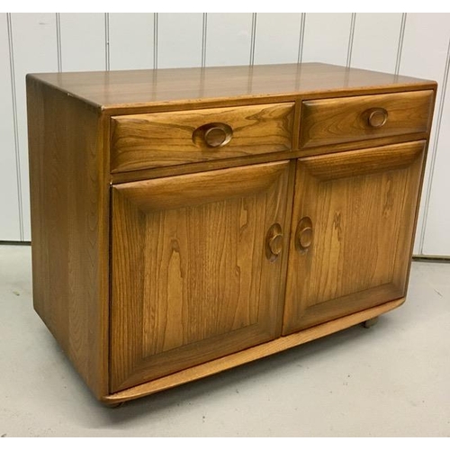 99 - An Ercol Windsor, dark elm sideboard/dining cabinet. Two drawers, over double cupboard. One drawer h... 