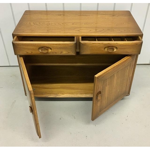 100 - An Ercol Windsor, dark elm sideboard/dining cabinet. Two drawers, over double cupboard. One drawer h... 